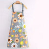 Gray floral print kitchen apron with adjustable neck strap and pockets hanging on a wooden hanger