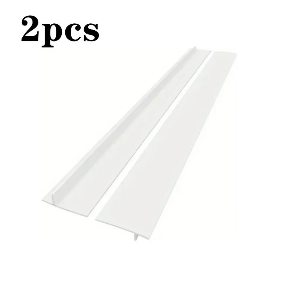 A pair of white T-shaped silicone stove gap covers are shown.