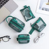A collection of green transparent mesh storage bags with zippers, including a pouch and a flat organizer, displayed on a whit