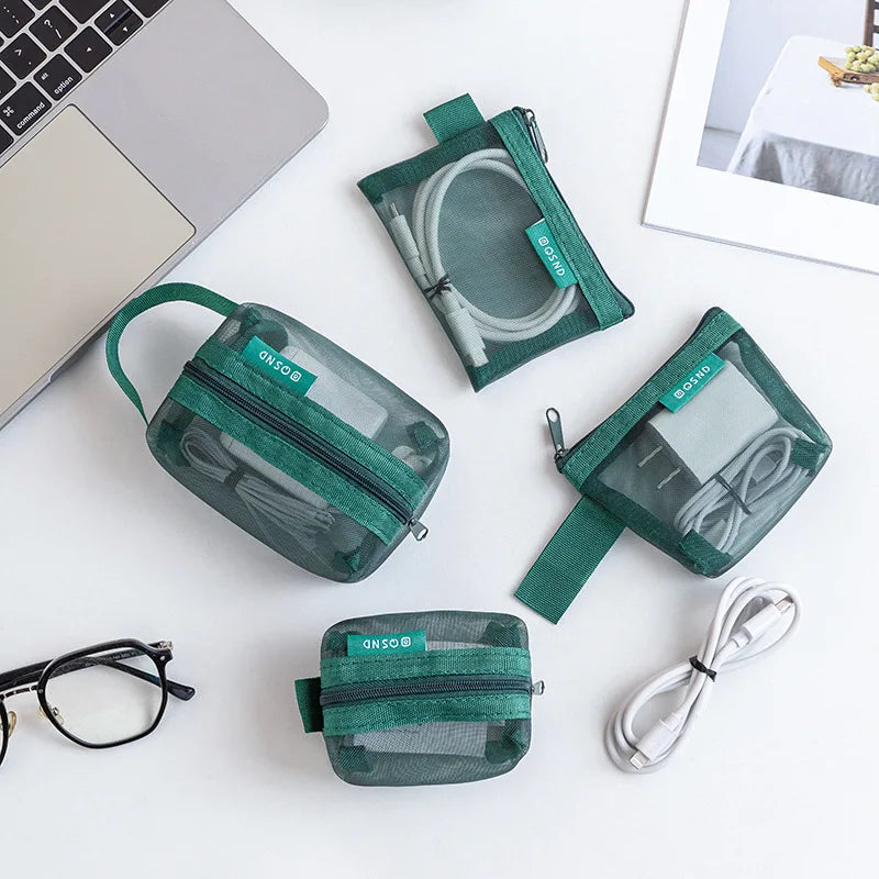 A collection of green transparent mesh storage bags with zippers, including a pouch and a flat organizer, displayed on a whit