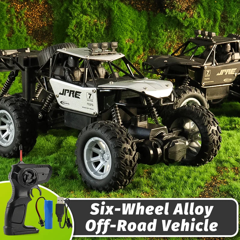 A black off-road RC vehicle with an alloy body and six wheels parked on green grass.
