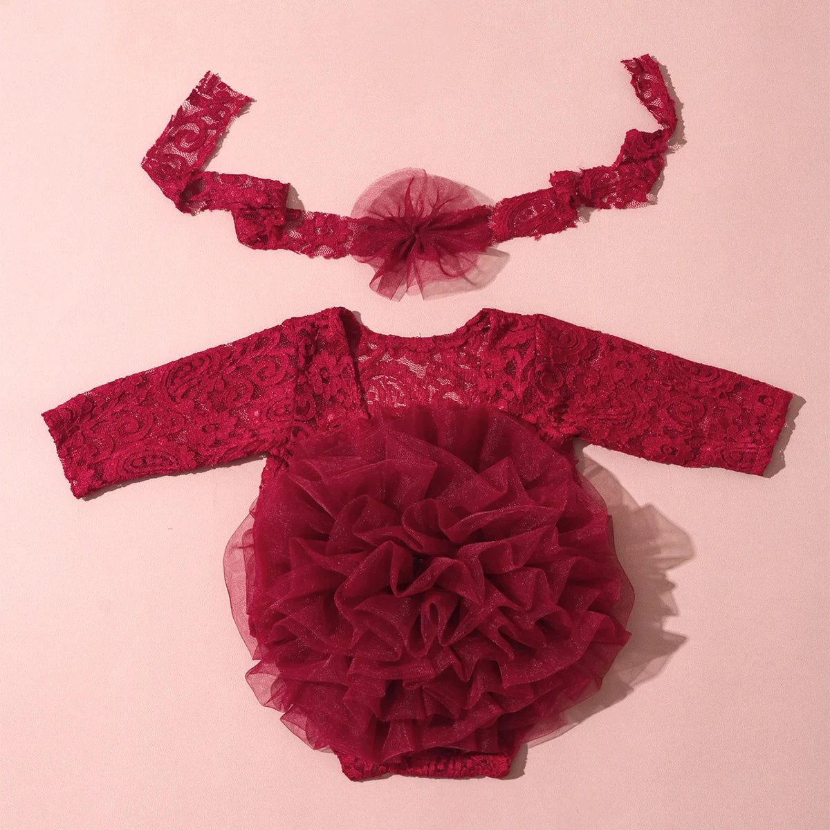 A deep red lace romper dress for a newborn princess tutu, complete with a matching sheer lace headband.