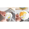 Hands dispense dish wand soap using a brush with replacement sponge heads into a stainless steel sink.