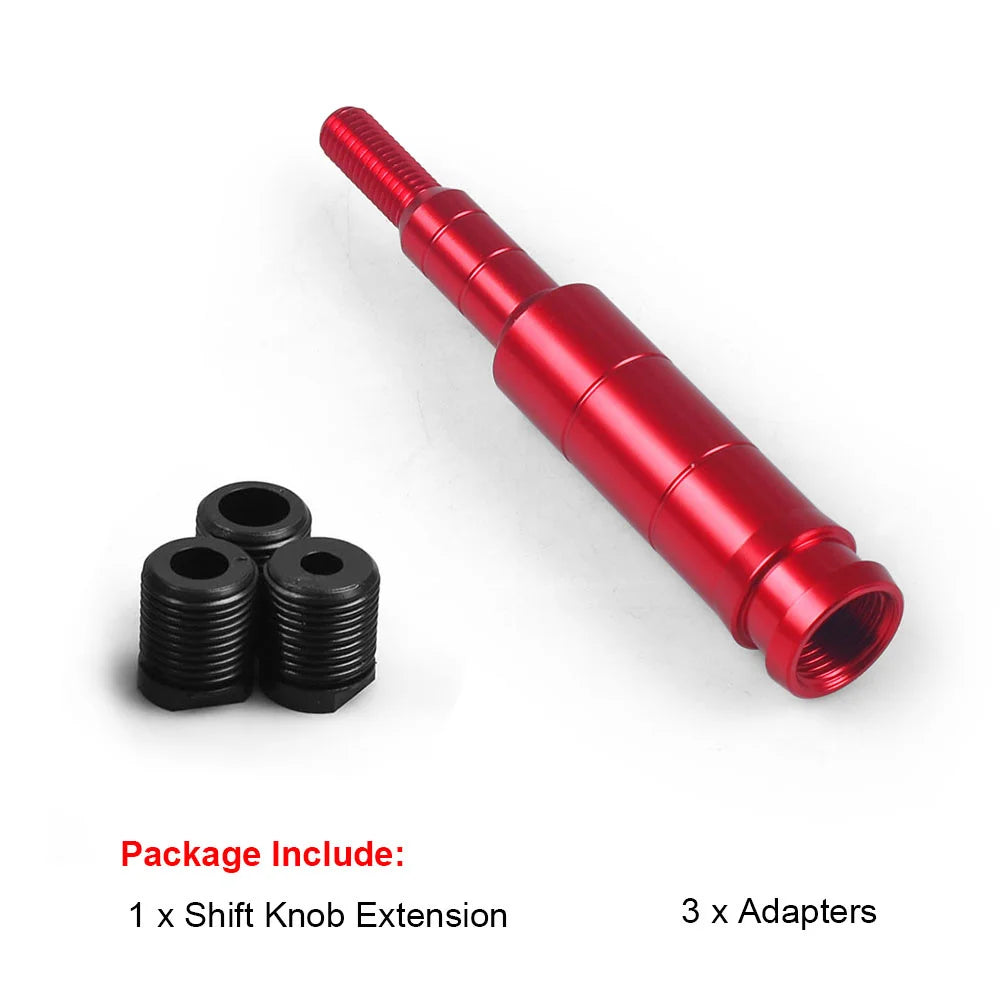 A red aluminum shift knob extension and three black adapters for a vehicle