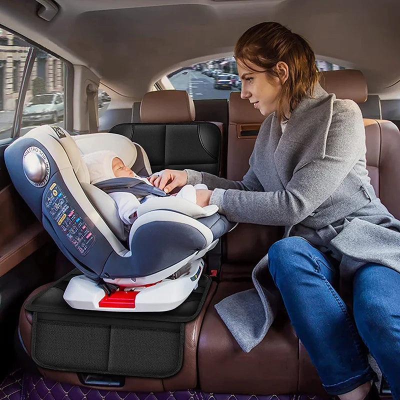 A woman is installing a Universal Car Seat Protector with Anti-Slip Base into a car seat inside a vehicle.