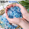 Hands hold crushed blue acrylic ice gems for vase fillers and decor