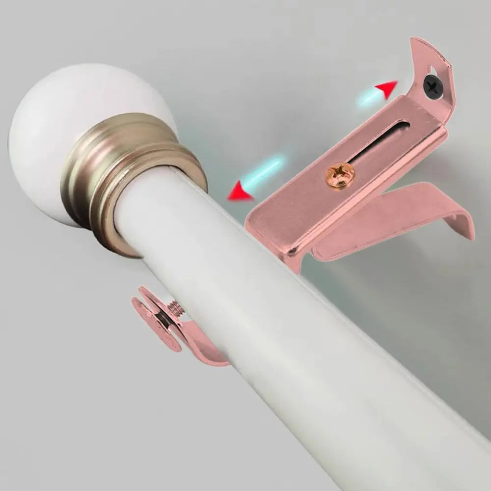 Close-up of a rose gold metal curtain rod bracket being installed onto a white pole.