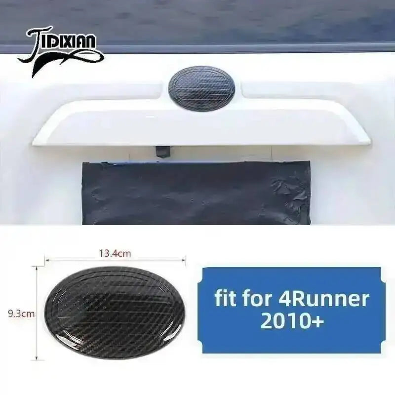 Carbon fiber trim kit for Toyota 4Runner featuring a black textured piece and a white mounting bracket.