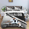 A black and white graphic duvet cover featuring a soccer player in action.