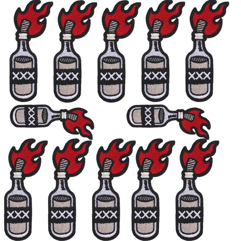 A set of ten embroidered iron-on patches depicting skulls and flames on glass bottles.