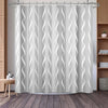 White shower curtain featuring a vertical wavy geometric stripe pattern hanging in a bathroom.