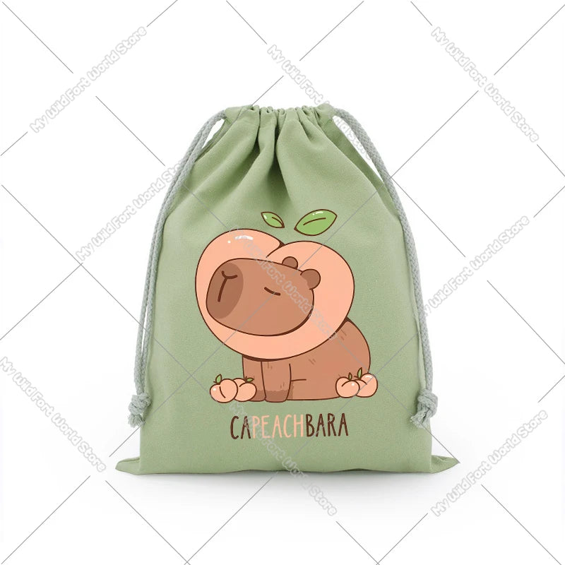 A light green drawstring storage bag featuring a cute illustration of a sleeping capybara face.