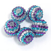 A set of five resin rhinestone beads with a two-tone purple and blue striped design.