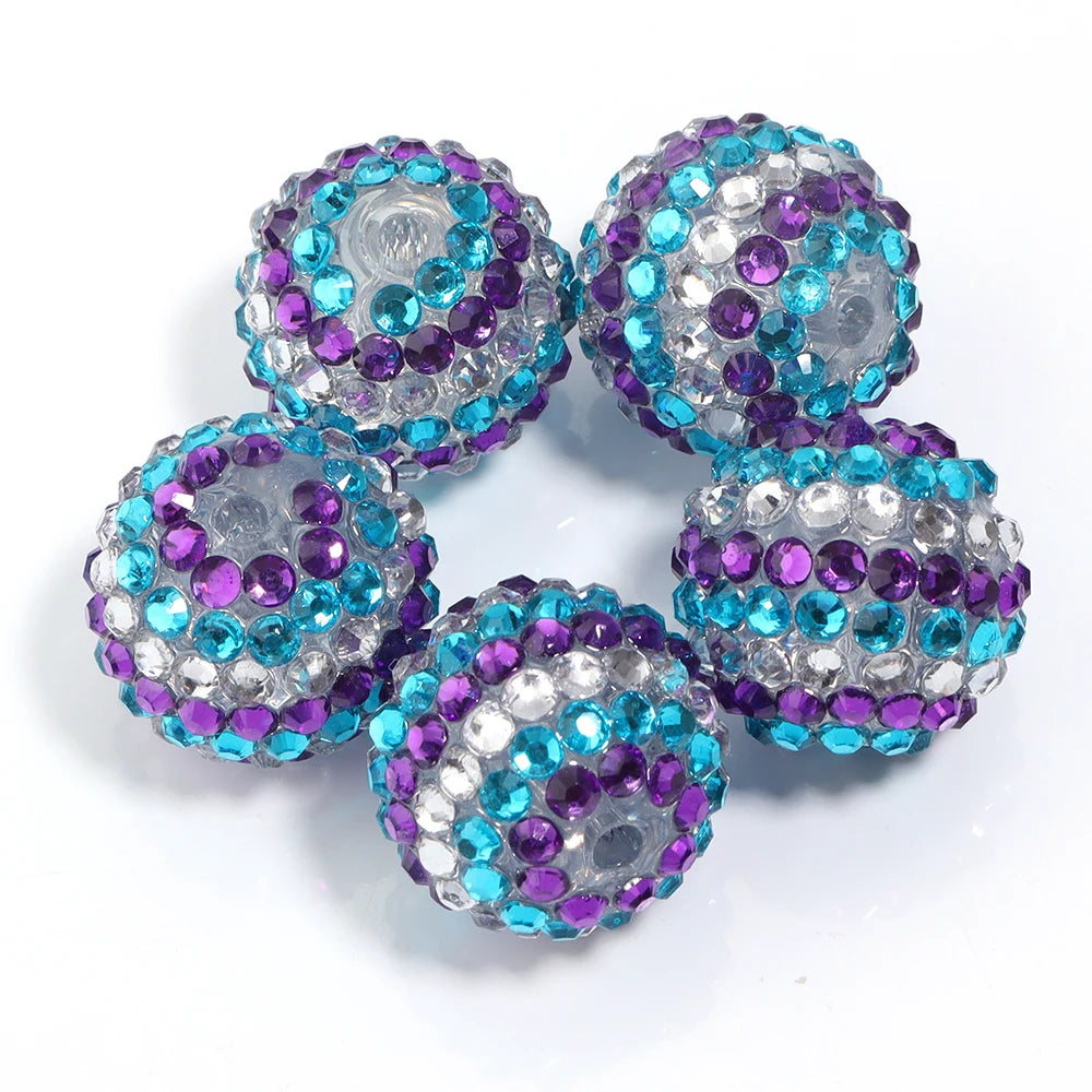 A set of five resin rhinestone beads with a two-tone purple and blue striped design.