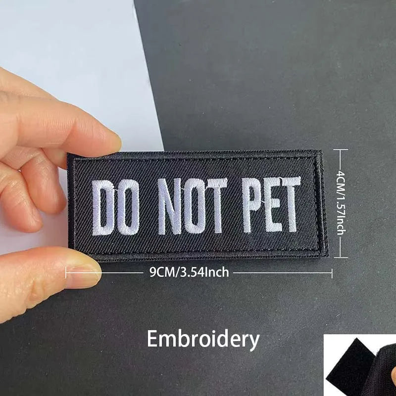 Black embroidered patch with white text DO NOT PET measuring 9cm by 3.54 inches