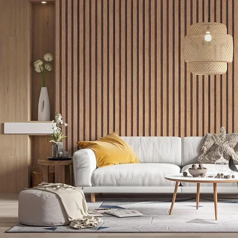 A modern living room featuring light wood slat accent walls, a white sofa, and woven pendant lighting.