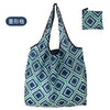 A reusable shopping tote bag with a geometric pattern in shades of green and blue.