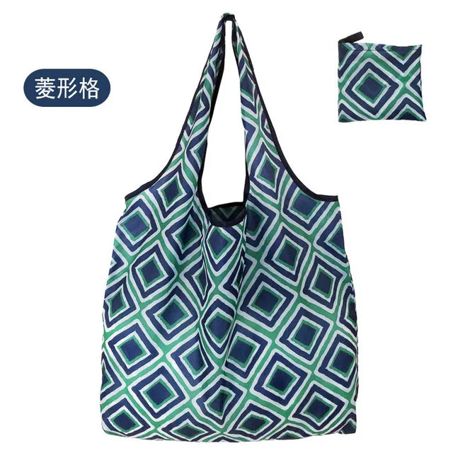 A reusable shopping tote bag with a geometric pattern in shades of green and blue.