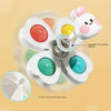 A set of white spinning bath toys for toddlers featuring a bear-shaped top and multiple colored suction cup discs.