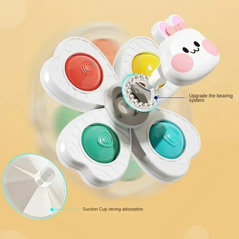 A set of white spinning bath toys for toddlers featuring a bear-shaped top and multiple colored suction cup discs.