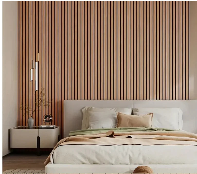 A bedroom featuring a wooden slat headboard wall panel and a bed with beige linens.