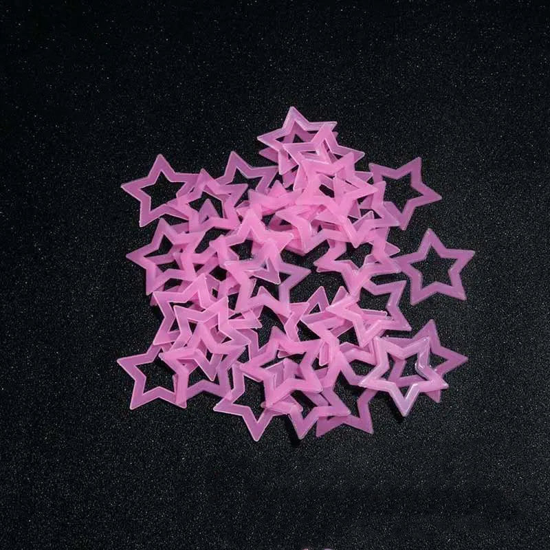A pile of pink glow-in-the-dark 3D star wall stickers for kids' rooms and bedrooms.