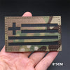 A close-up of a rectangular tactical patch featuring the American flag design in camouflage fabric.