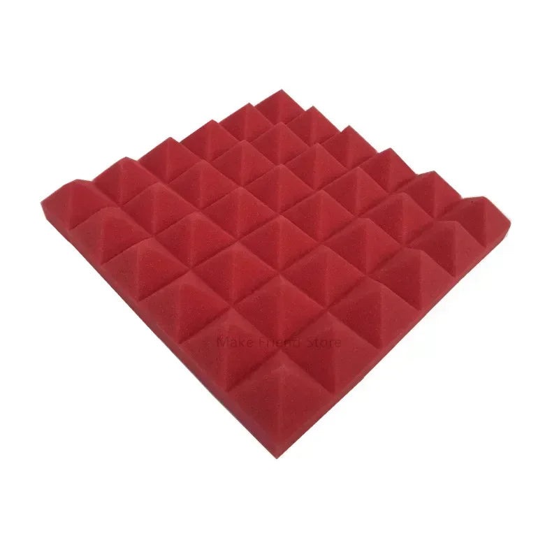 A pack of red pyramid acoustic foam panels used for soundproofing.