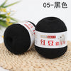 A ball of black yarn labeled 05-Black, displayed on a woven mat.