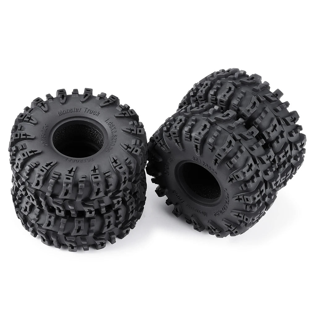A pair of black mud terrain wheels and tires for RC crawlers.