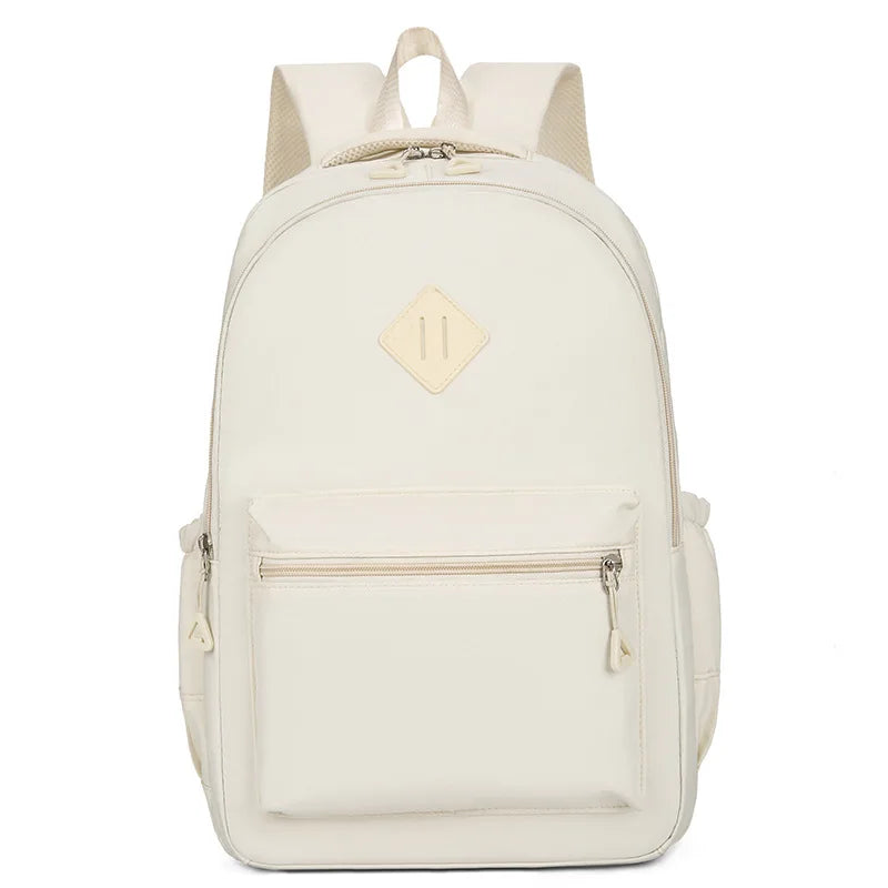 A cream-colored urban nylon backpack with a flap closure and zippered pockets.