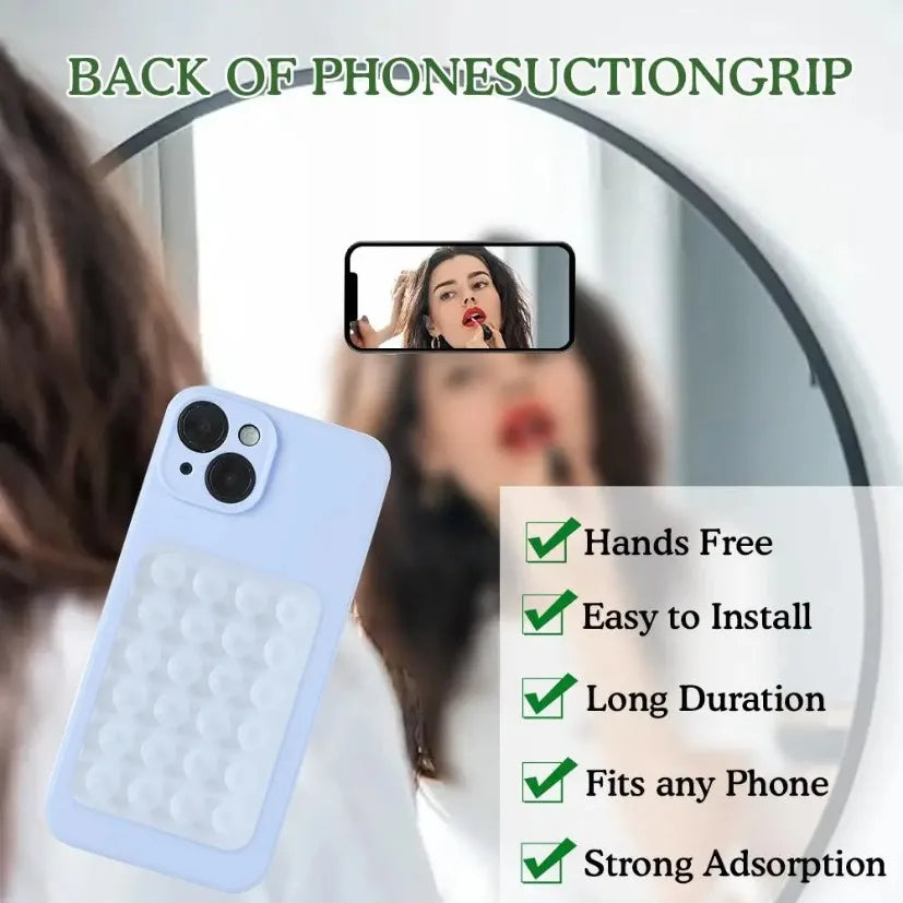 A light blue silicone suction cup phone grip is shown with a reflection of a person in a mirror.