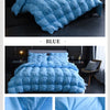 A blue quilted duvet cover and bedding set featuring 95% high down insulation.