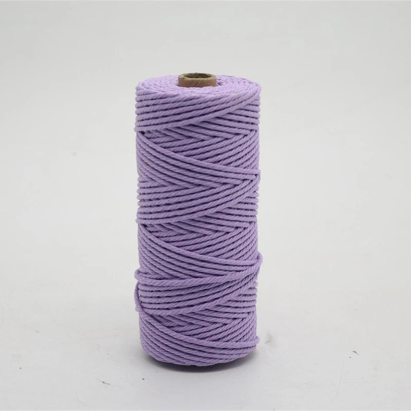 A spool of purple macrame cord, 3mm/4mm thickness, used for crafting.