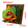 A kit of 2688 mosaic building blocks shaped like a green dragon and foliage, displayed on a brown wooden board.