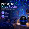 A starry sky projector night light illuminating a child's bedroom with soft blue and purple light.