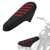 Black motorcycle seat cover with red stripes and anti-slip particles installed on a bike.