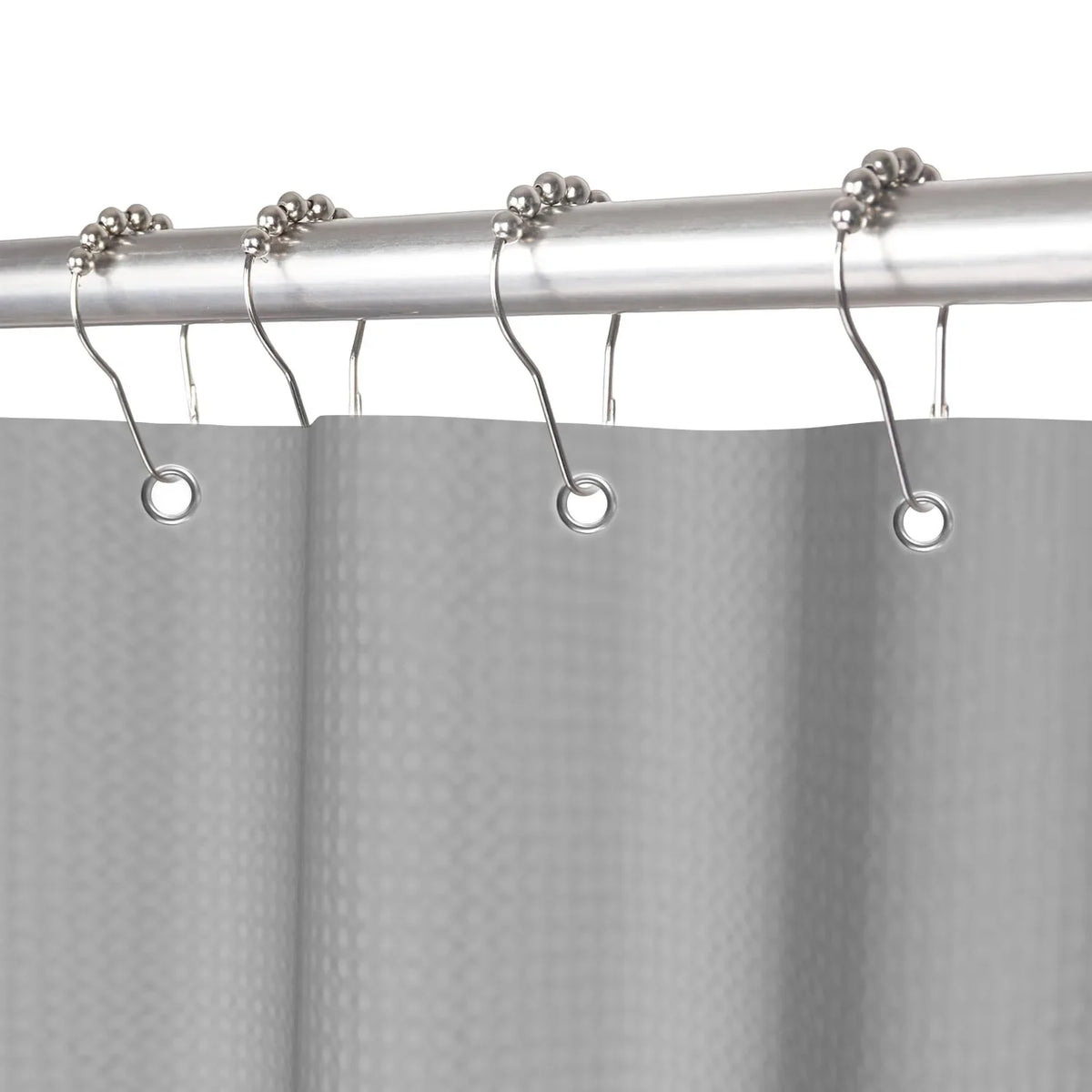 Silver shower curtain rod with hanging rings and a gray waffle weave shower curtain