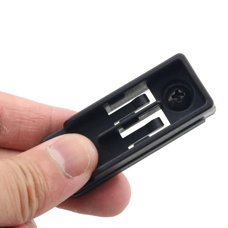 A hand holds a black belt clip hook bit holder for cordless drills.