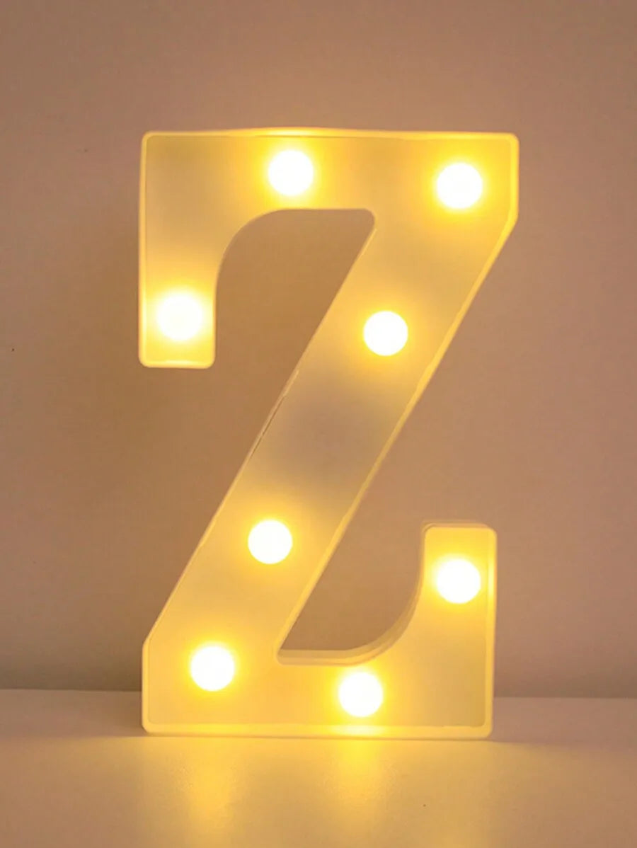 A glowing yellow LED letter Z night light displayed against a white background.