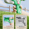 A hand holds a green dinosaur foam airplane launcher toy, demonstrating how to load and fire the toy.