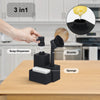 A black 3-in-1 kitchen dispenser holds a soap dispenser, brush, and sponge on a wooden surface.