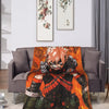An orange and black themed throw blanket featuring a character from My Hero Academia