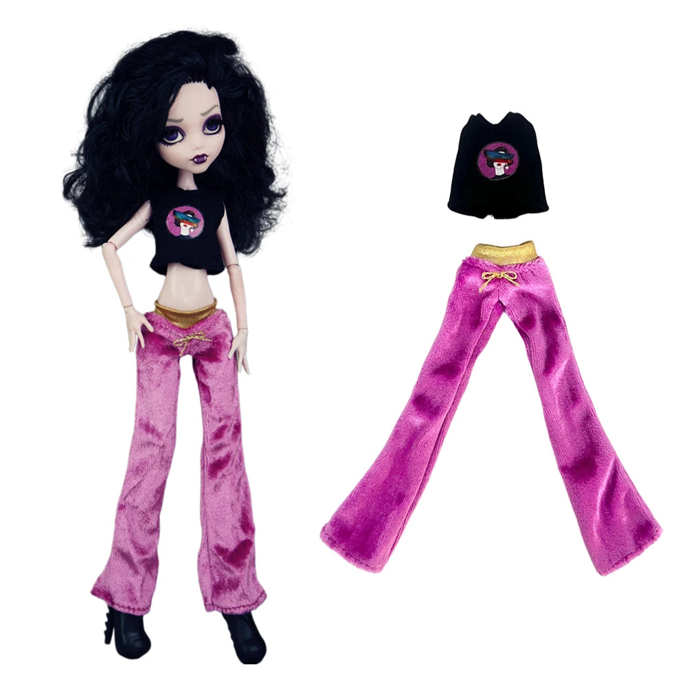 A fashion doll outfit featuring a black top and bright pink velvet pants with a matching black hat.