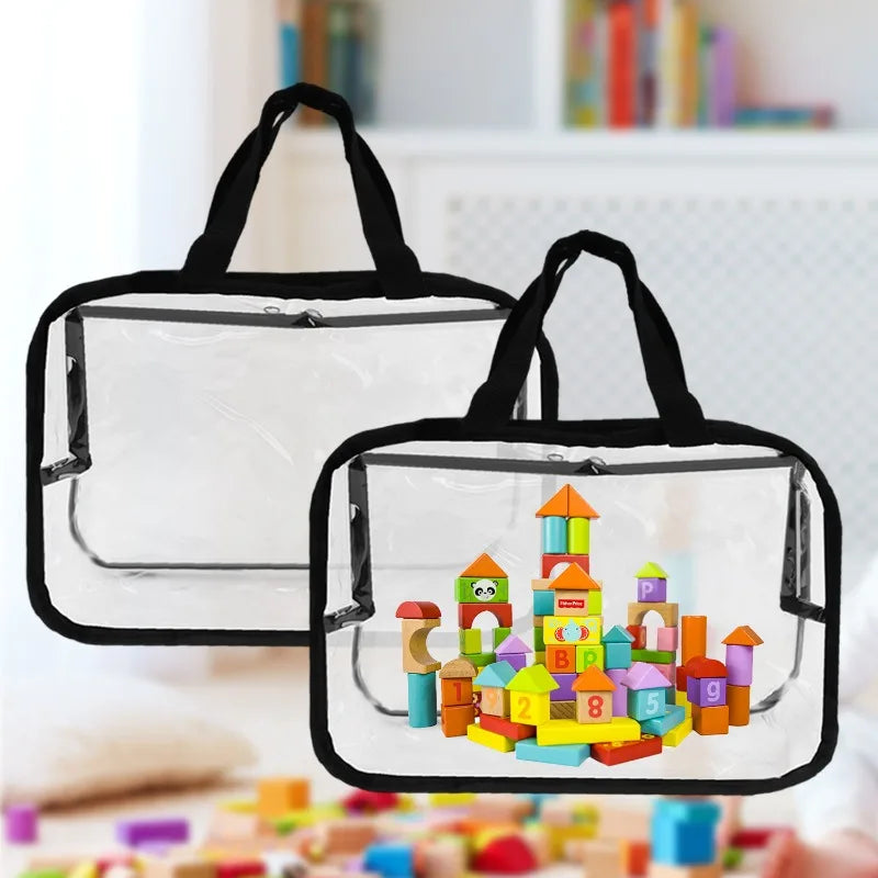 A clear transparent storage bag with a black zipper and handles is shown, filled with colorful building toys.