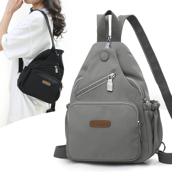 A gray waterproof nylon crossbody sling bag with a zipper and adjustable strap is shown against a white background.