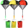 A set of colorful hand-thrown parachute toys in green, yellow, and red.