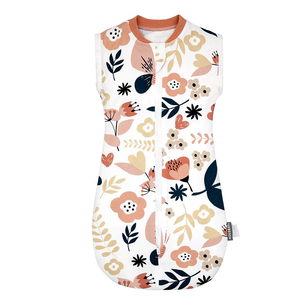 A white baby sleep sack featuring a floral pattern in shades of pink, peach, and dark green.