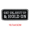 Black embroidered iron-on letter patch with white text that reads GET ON, SHUT UP & HOLD ON