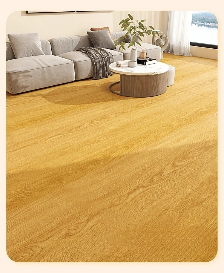 A close-up view of light natural wood grain floor stickers installed on a wooden floor.